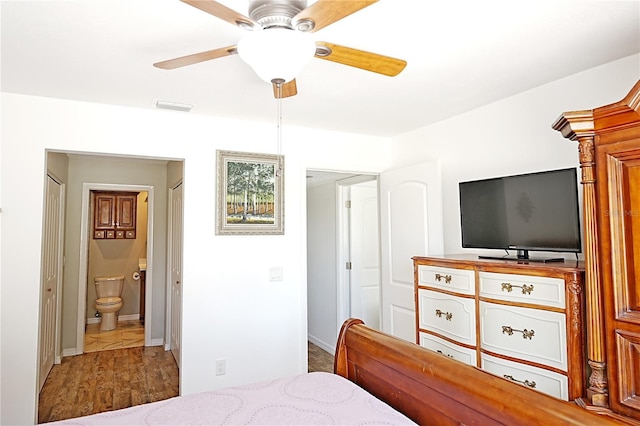 bedroom with ensuite bath, light wood-type flooring, and ceiling fan