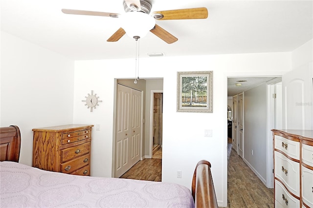 bedroom featuring a closet, hardwood / wood-style flooring, and ceiling fan