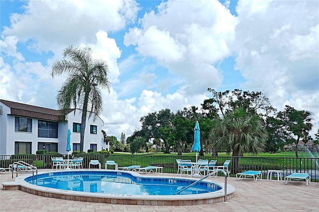 view of pool featuring a patio area and a lawn