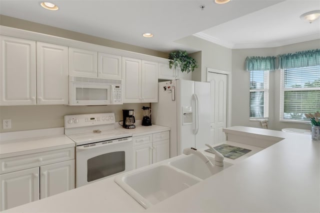 kitchen featuring crown molding, white appliances, white cabinetry, and sink