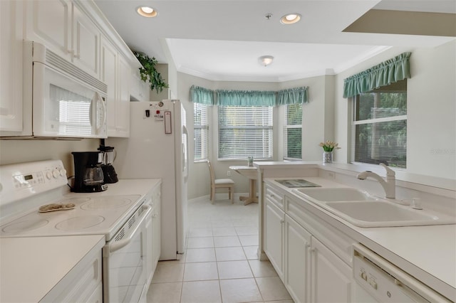 kitchen with white cabinets, white appliances, and a wealth of natural light