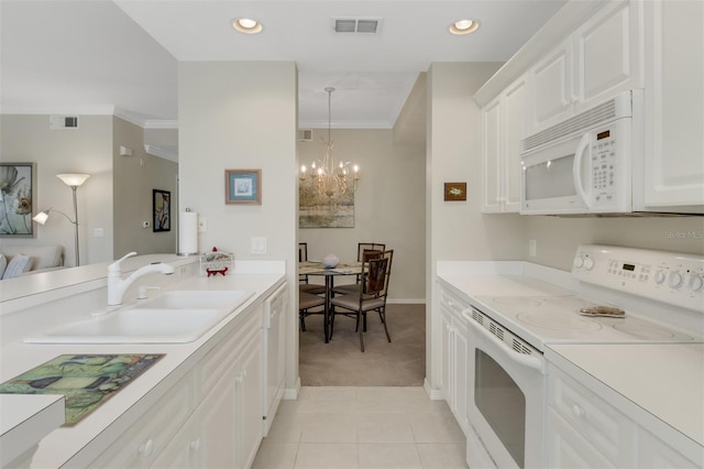 kitchen featuring white cabinetry, white appliances, decorative light fixtures, sink, and a notable chandelier