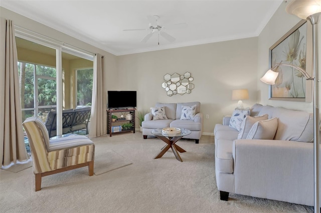 living room featuring ornamental molding, light carpet, and ceiling fan