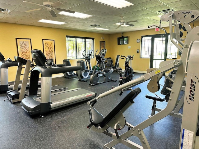 workout area with a drop ceiling and ceiling fan