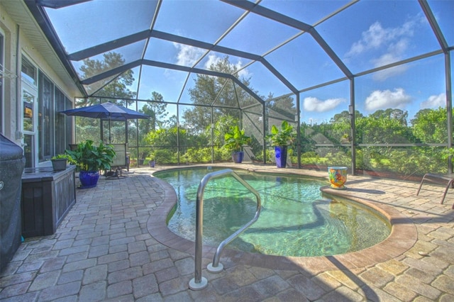 view of pool with a patio area and a lanai