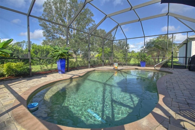 view of swimming pool with a patio and a lanai