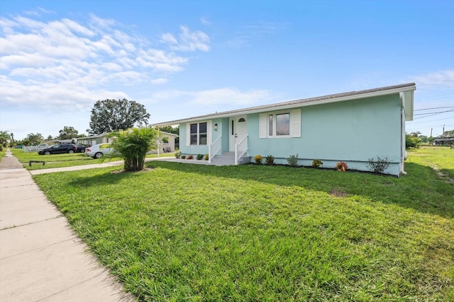 ranch-style house with a front lawn