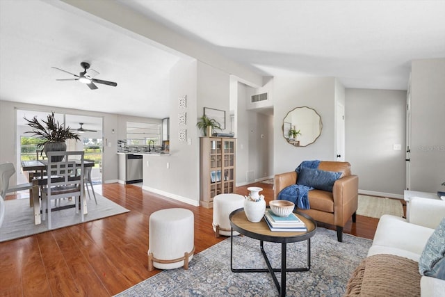 living room featuring ceiling fan, sink, lofted ceiling with beams, and hardwood / wood-style floors