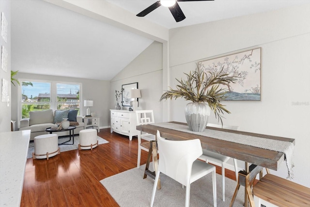 dining space featuring ceiling fan, dark hardwood / wood-style floors, beam ceiling, and high vaulted ceiling