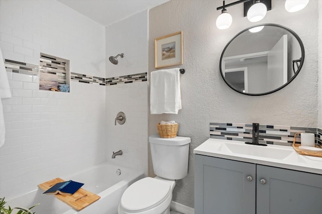 full bathroom featuring backsplash, vanity, tiled shower / bath combo, and toilet