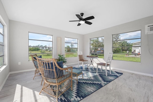 sunroom featuring ceiling fan and a wall mounted air conditioner