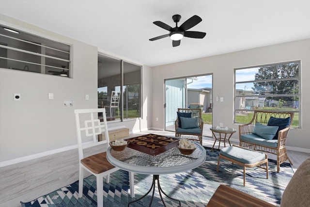 living room featuring wood-type flooring and ceiling fan