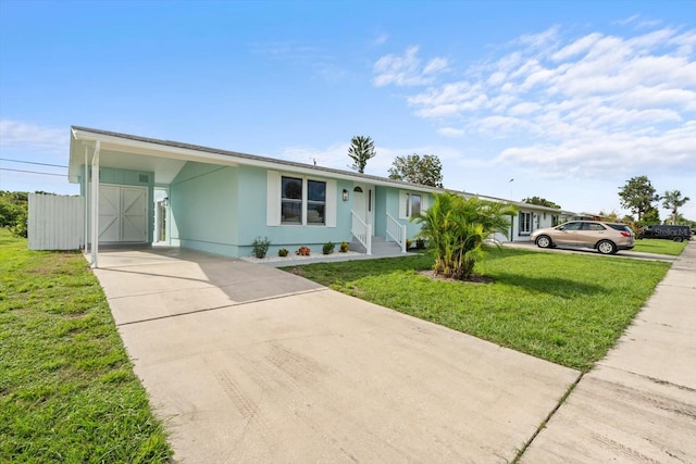 view of front facade featuring a front lawn and a carport