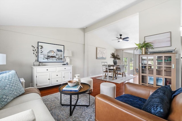 living room with ceiling fan, lofted ceiling with beams, and dark hardwood / wood-style floors