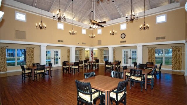 dining room with french doors, a towering ceiling, ceiling fan, and wood ceiling