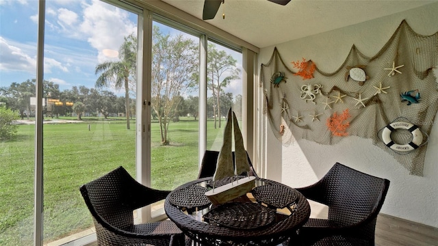 sunroom featuring ceiling fan