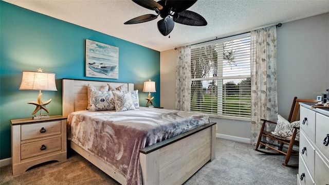 carpeted bedroom with a textured ceiling and ceiling fan