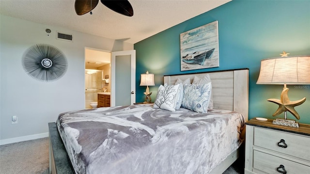 bedroom with carpet flooring, ceiling fan, a textured ceiling, and ensuite bath