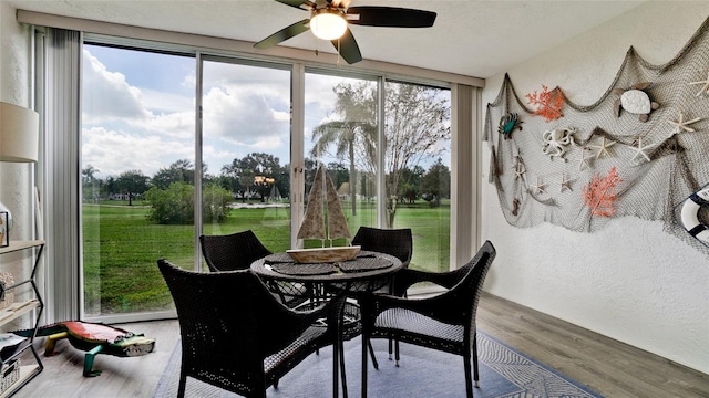 sunroom / solarium featuring ceiling fan