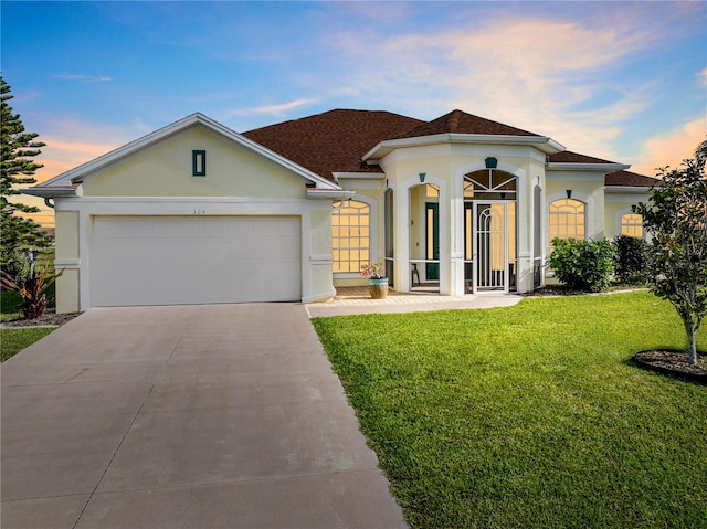 view of front of house with a lawn and a garage