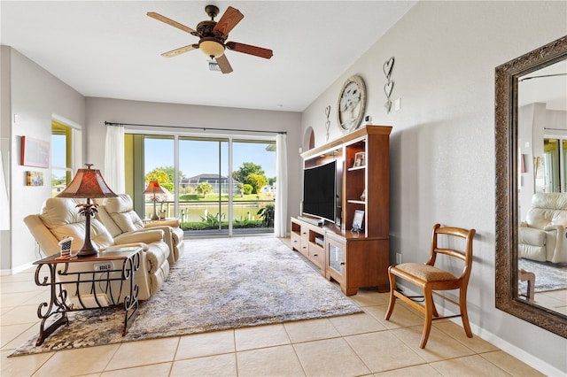 living room with ceiling fan and light tile patterned floors