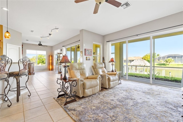 living room with ceiling fan and light tile patterned floors