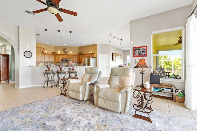 living room with ceiling fan and light tile patterned floors