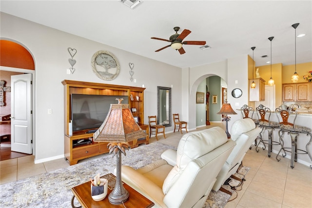 living room featuring light tile patterned floors and ceiling fan