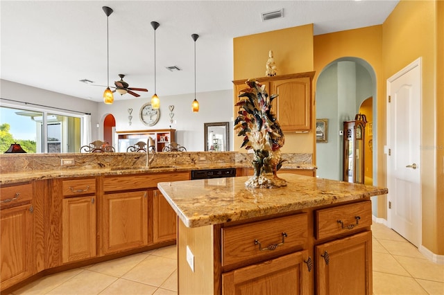 kitchen with ceiling fan, a center island, light tile patterned floors, and sink