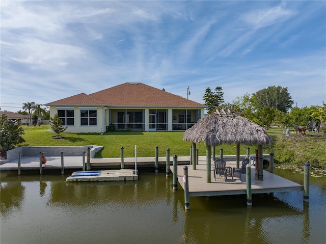 dock area featuring a lawn and a water view