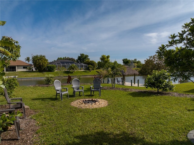 view of home's community with a lawn and a water view