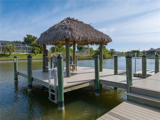 dock area featuring a water view and glass enclosure