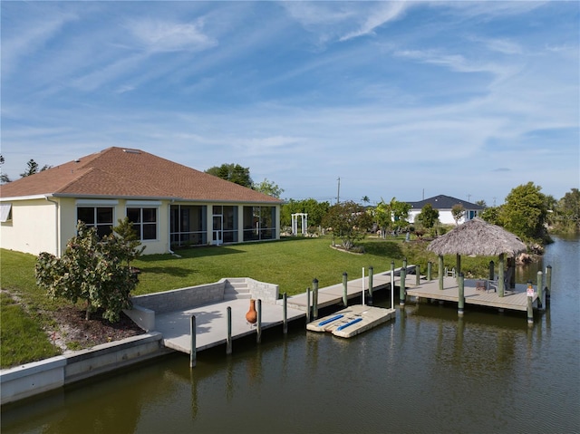 view of dock featuring a gazebo, a lawn, and a water view