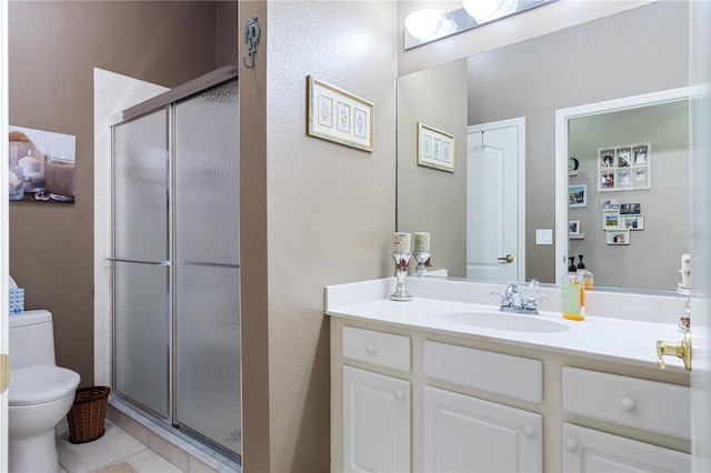 bathroom with walk in shower, vanity, toilet, and tile patterned floors