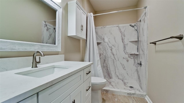 bathroom with vanity, curtained shower, and toilet