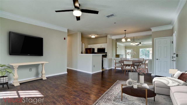 living room with ceiling fan, ornamental molding, and dark wood-type flooring