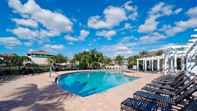 view of swimming pool featuring a patio and a pergola