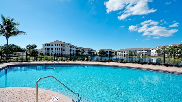 view of swimming pool with a water view