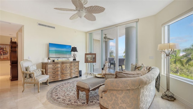 sitting room featuring ceiling fan and a wealth of natural light