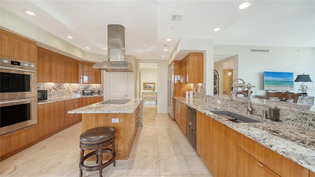 kitchen featuring black appliances, sink, a kitchen island, island exhaust hood, and backsplash