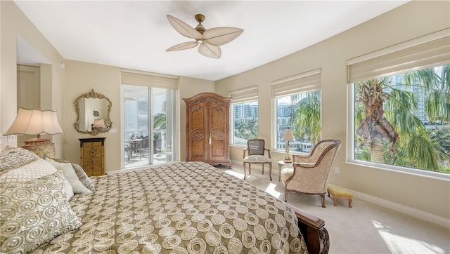 bedroom with access to outside and ceiling fan