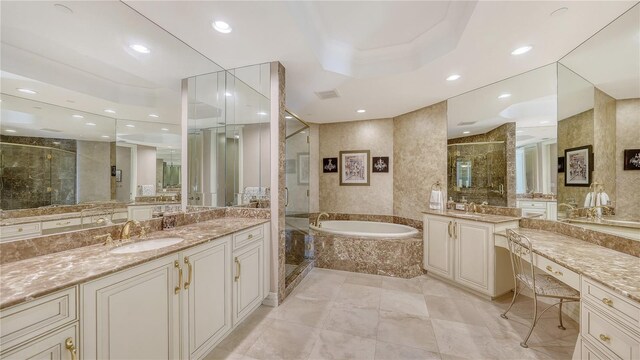 bathroom with vanity and independent shower and bath