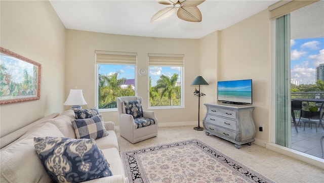 living room with light carpet and ceiling fan