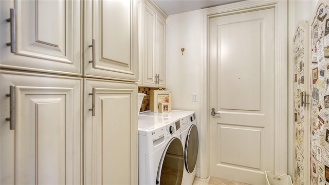 washroom with washing machine and dryer and cabinets