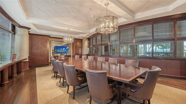 dining space with coffered ceiling, wood-type flooring, and a chandelier