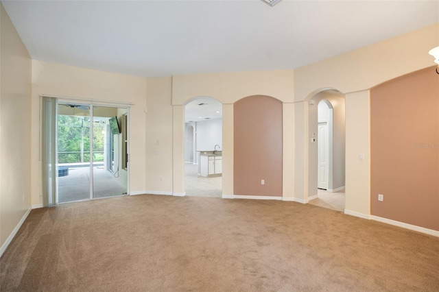 empty room featuring light carpet and sink