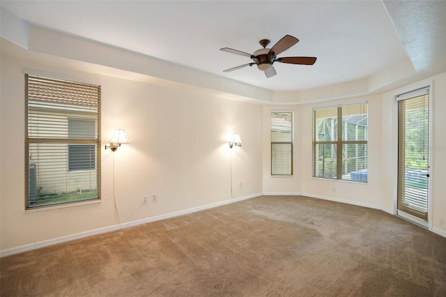 carpeted spare room with ceiling fan