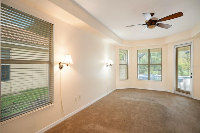 empty room featuring ceiling fan and carpet