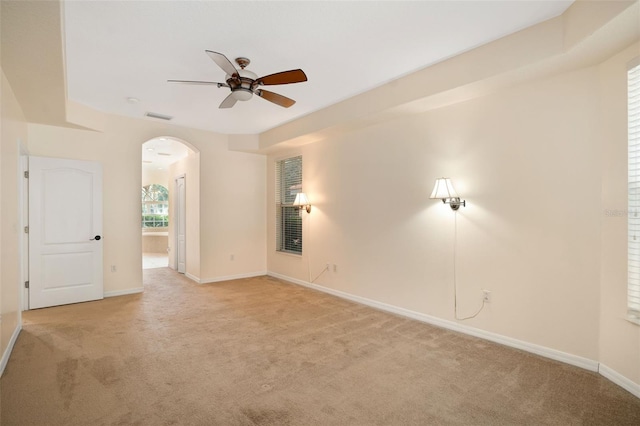 carpeted empty room featuring ceiling fan