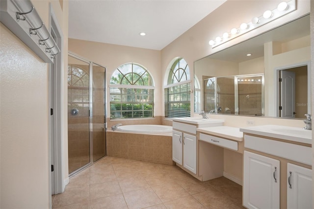 bathroom with tile patterned floors, vanity, and independent shower and bath